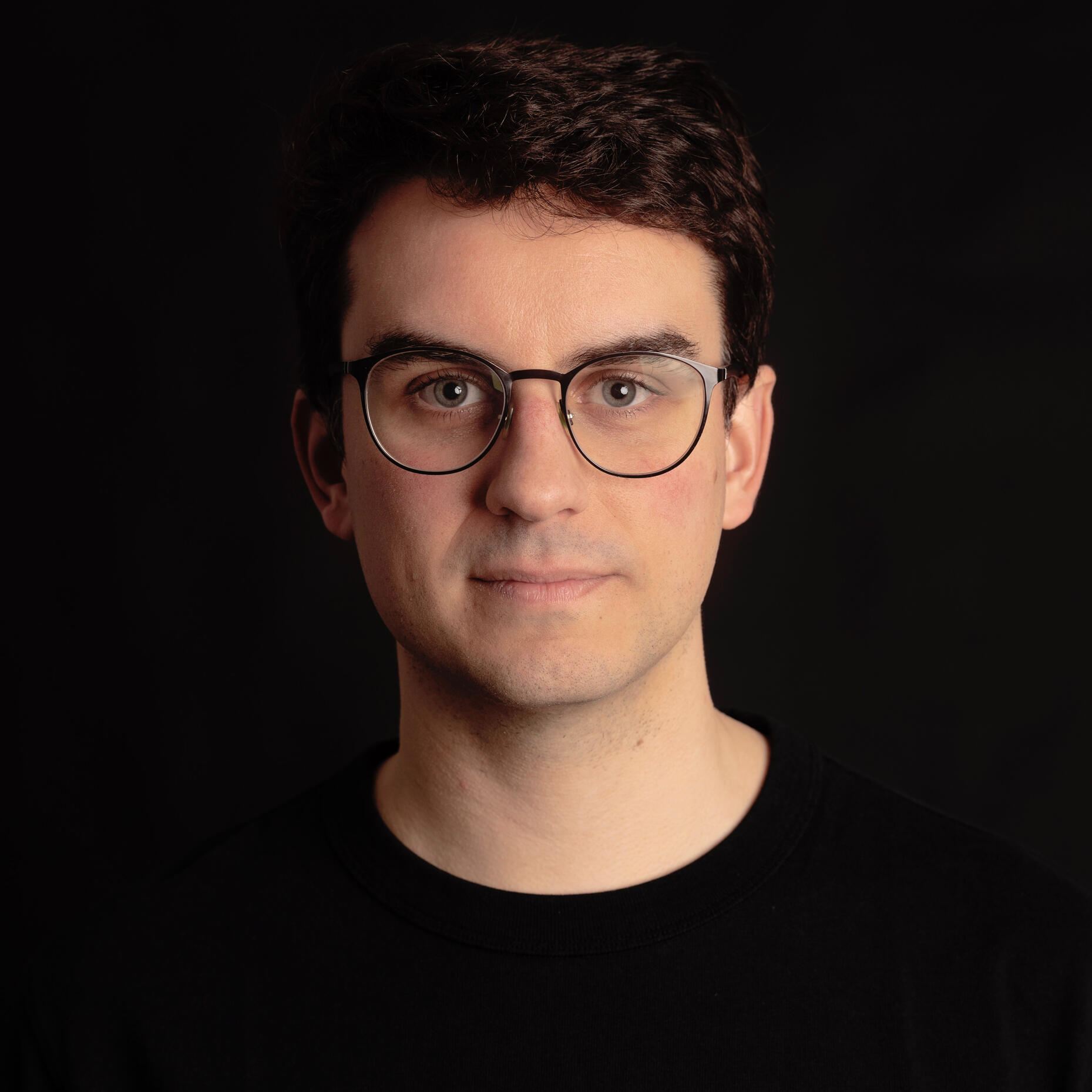 headshot of Gabriel RC on a black backgorund with a black t-shirt